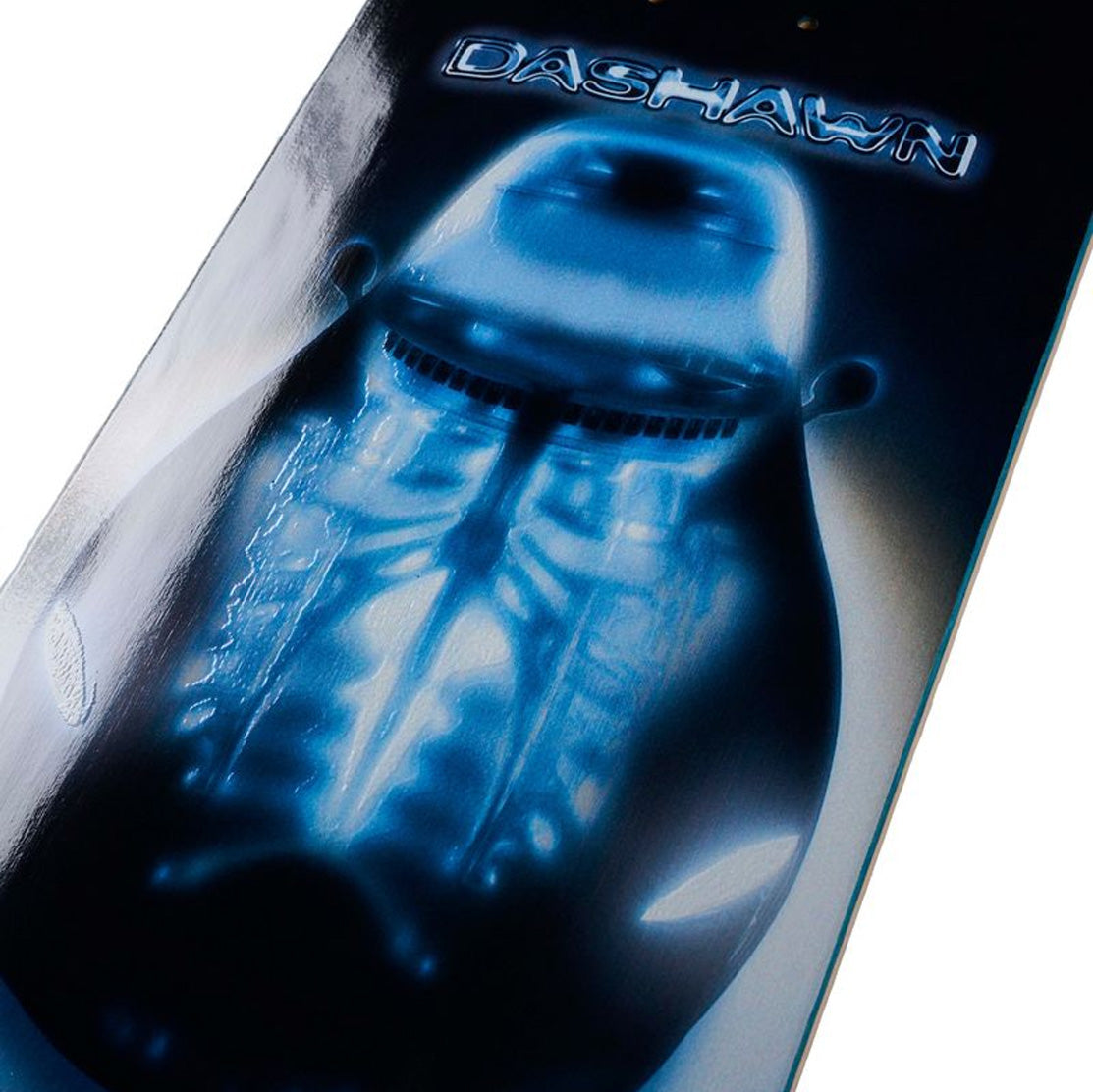 Close-up of April Dashawn Cage skateboard deck featuring a glowing blue alien-like car graphic on a black background.