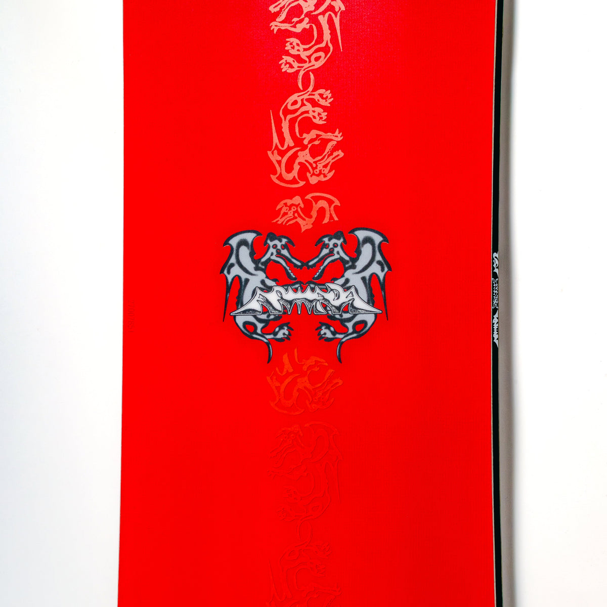 Closeup of the 26/27 Armada squonk snowboard red top sheet with art of dragons