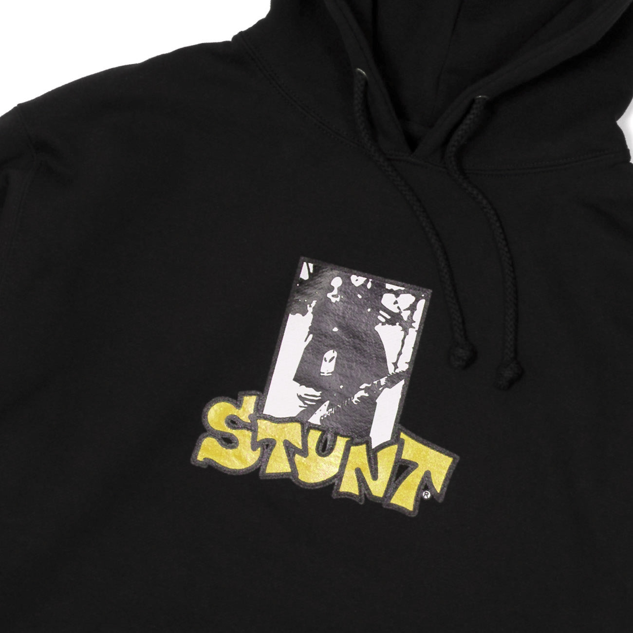 Black Stunt hoodie with screenprinted fron guitar hero logo with yellow stunt Close up