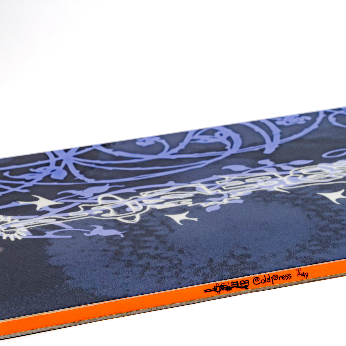 Closeup of the Armada women's cold press snowboard with blue top sheet and orange sidewall