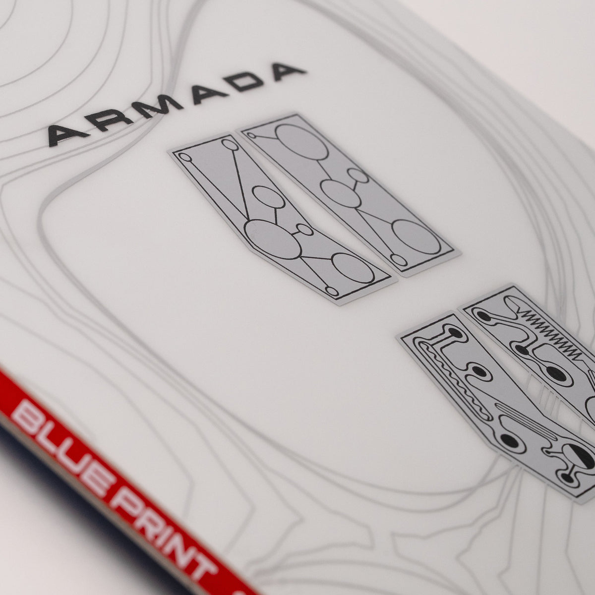 Close-up of Armada Blueprint snowboard top featuring white top sheet and red sidewall