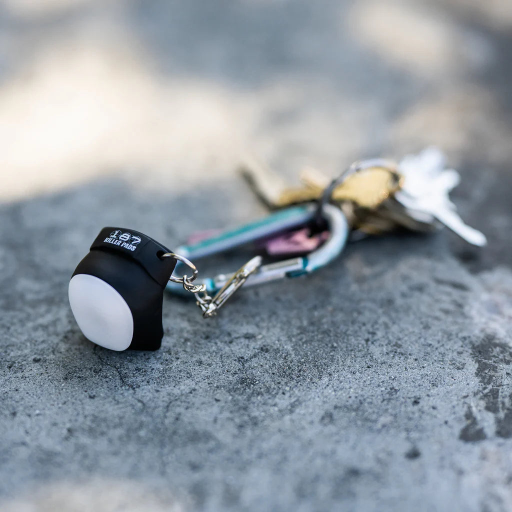 Miniature 187 skateboard kneepad keychain on a set of keys