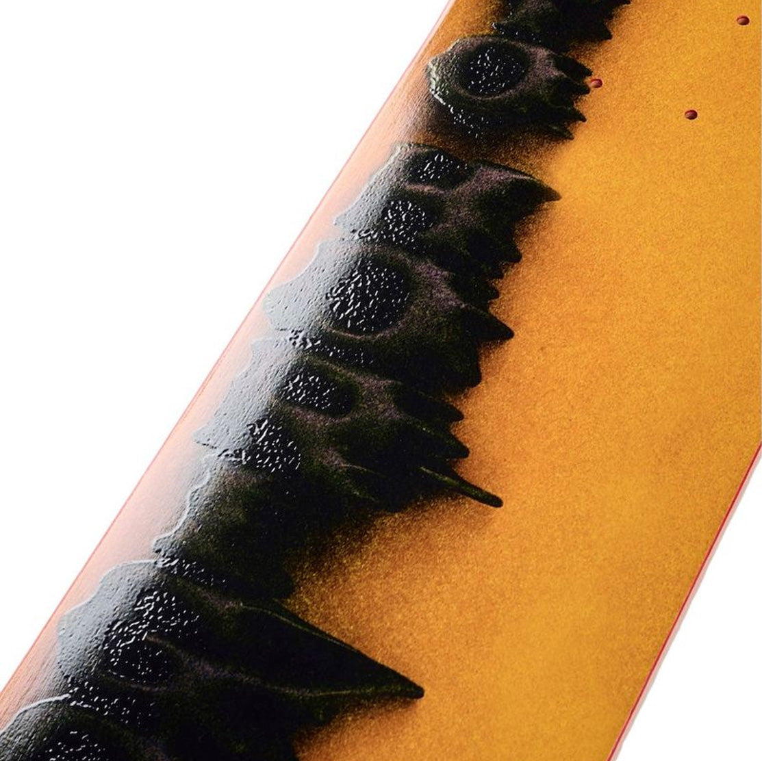 Close-up of a yellow Yuto April Stamped skateboard deck with black embossed design with red background