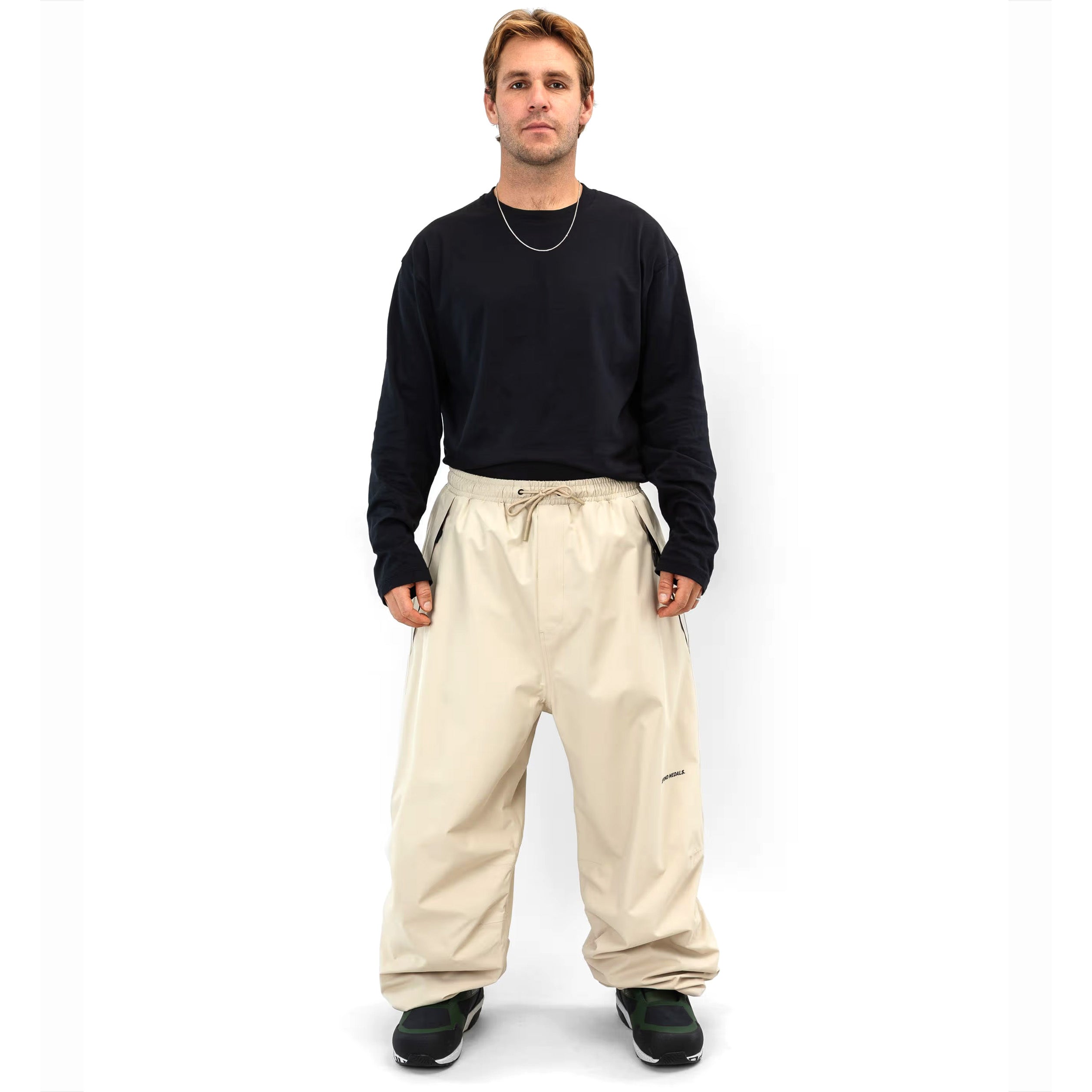 Beige Beyond Medals Park snowboard pant with a baggy fit on body 2
