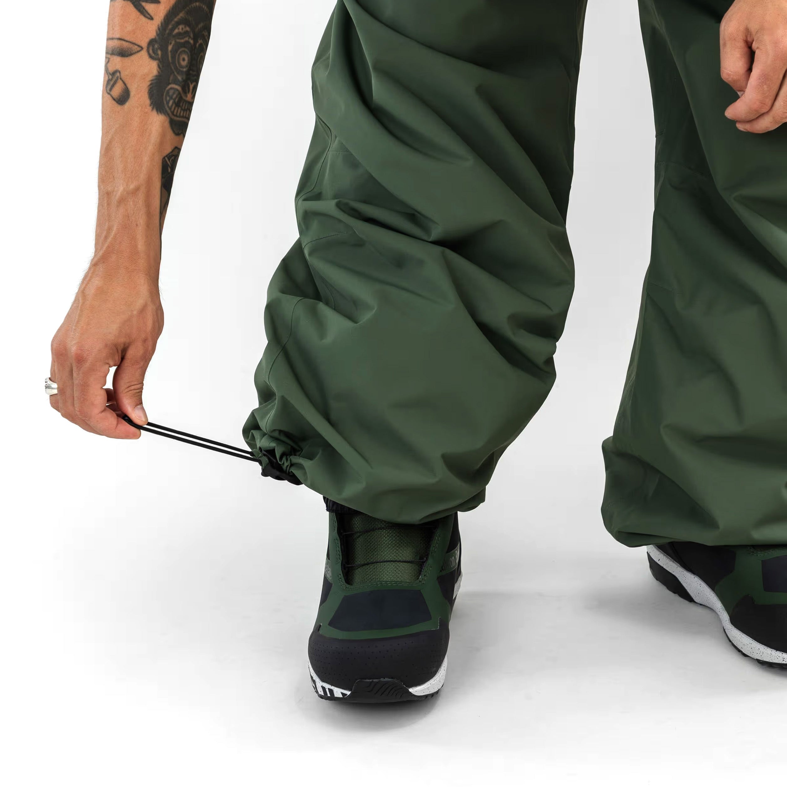 Green Beyond Medals Park snowboard pants with a baggy fit on body cinch at ankle