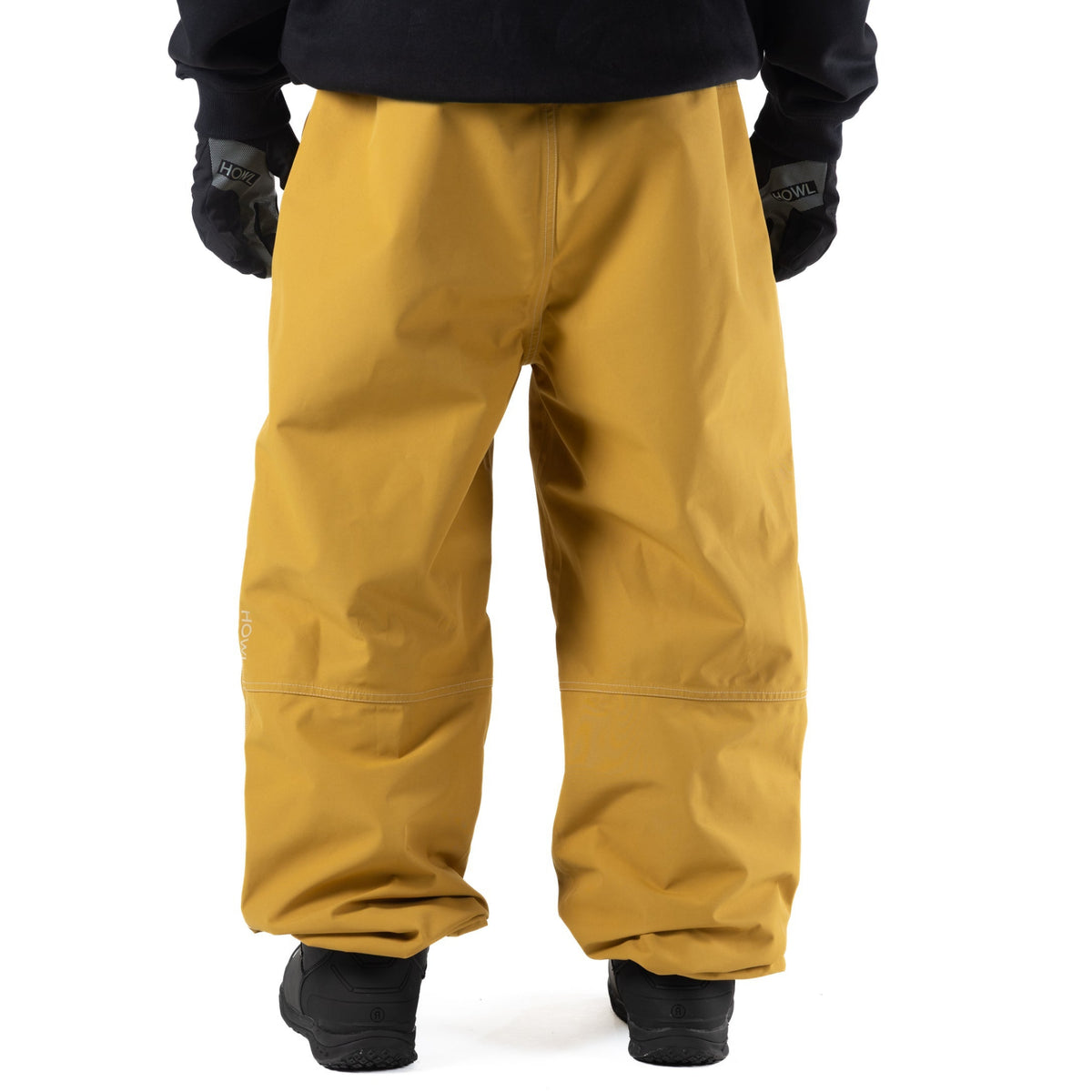 Yellow Howl workwear snowbaord pants with a loose fit on person back view