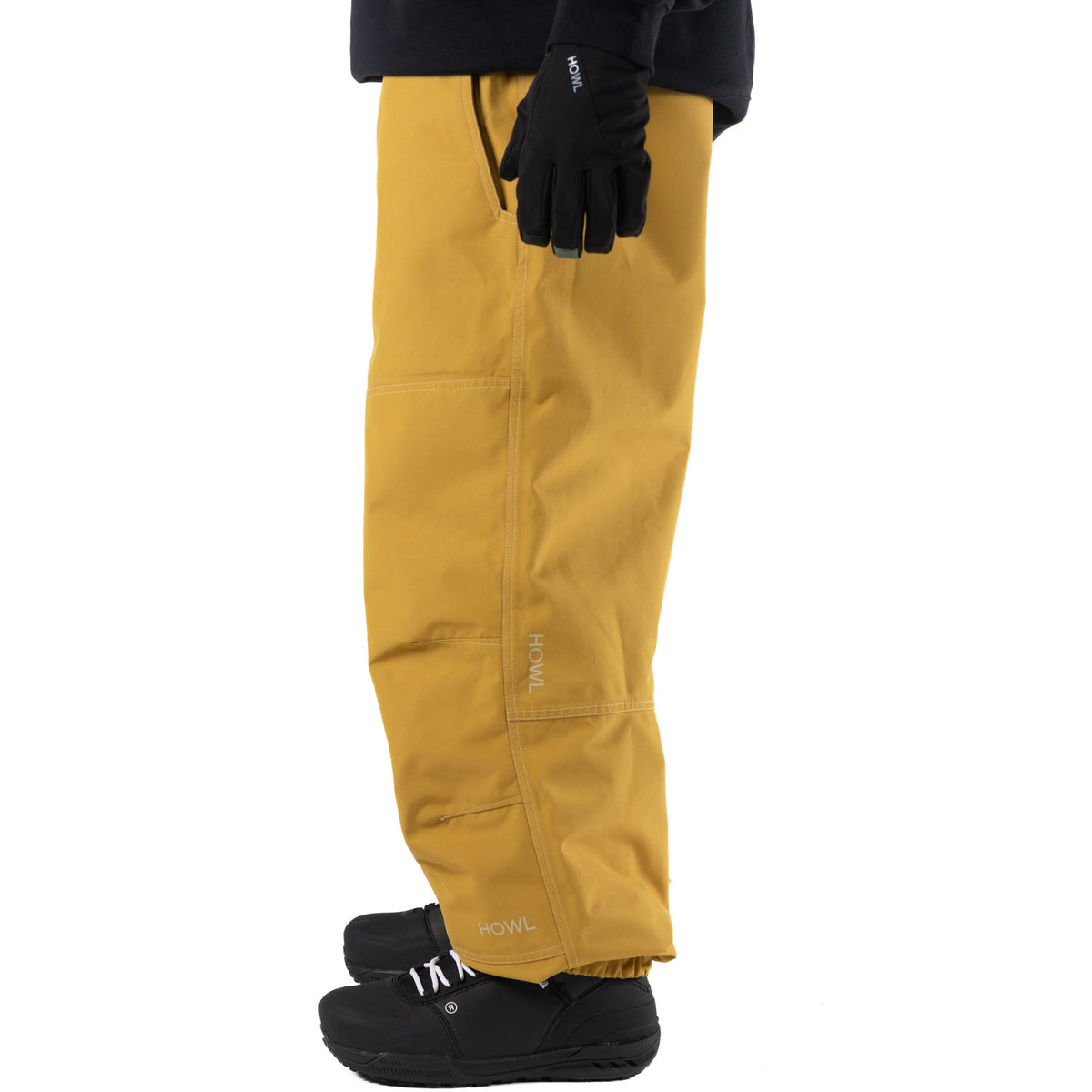 Yellow Howl workwear snowbaord pants with a loose fit on person side view