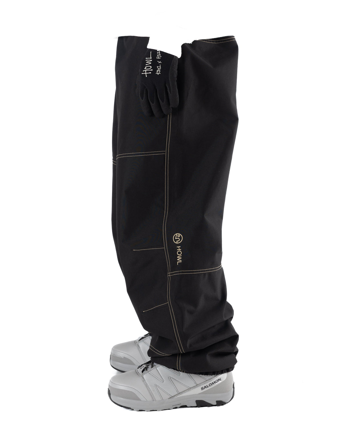 Black Public x Howl snowboard pants with contrast light beige stitching featureing  aloose fit on person side view