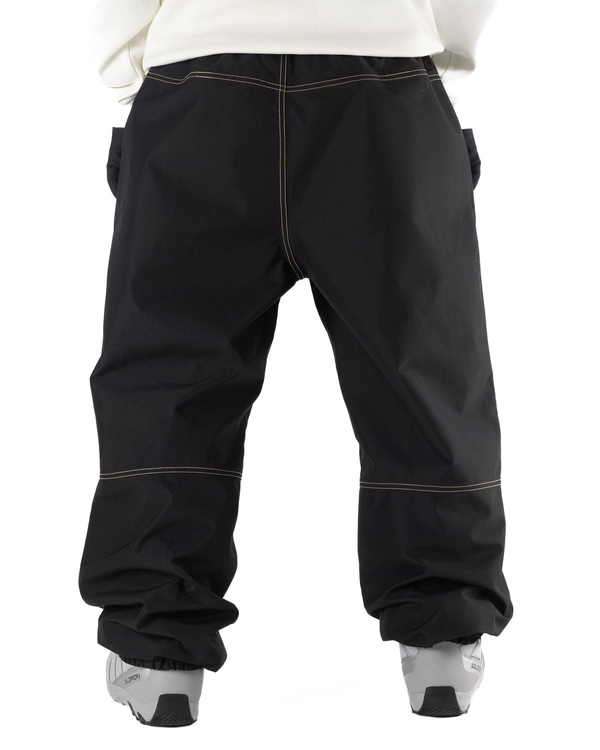 Black Public x Howl snowboard pants with contrast light beige stitching featureing  aloose fit on person back view