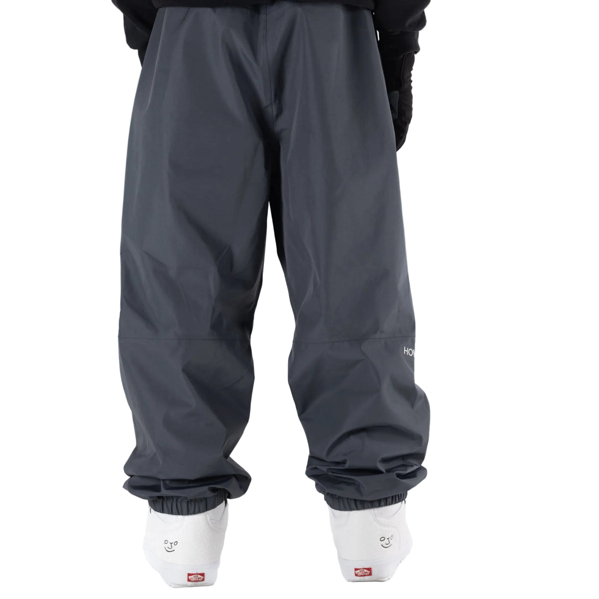 Dark grey Howl snowboard pants on model with a loose fit backview