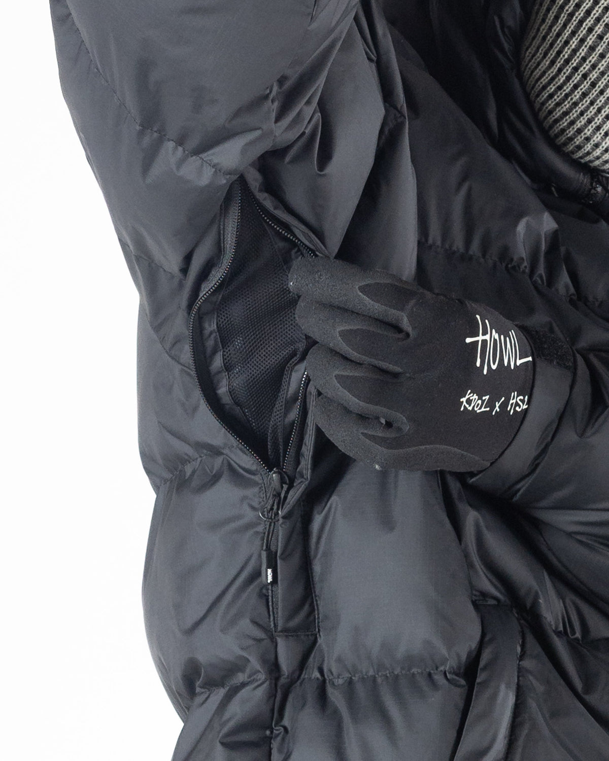 Black Howl puffy jacket showing arm hole vents