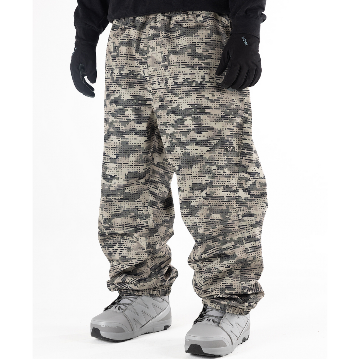green and tan camo Howl snowboard pants  on model witha loose fit front view