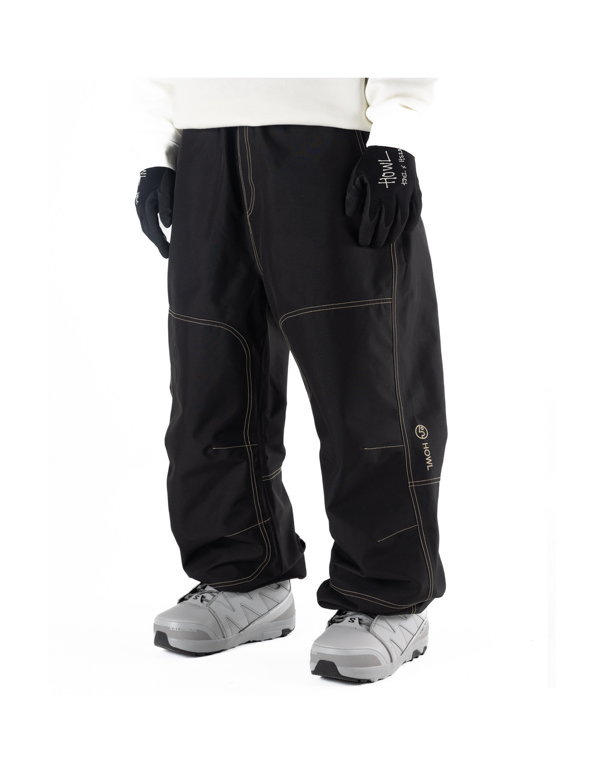 Black Public x Howl snowboard pants with contrast light beige stitching featureing  aloose fit on person