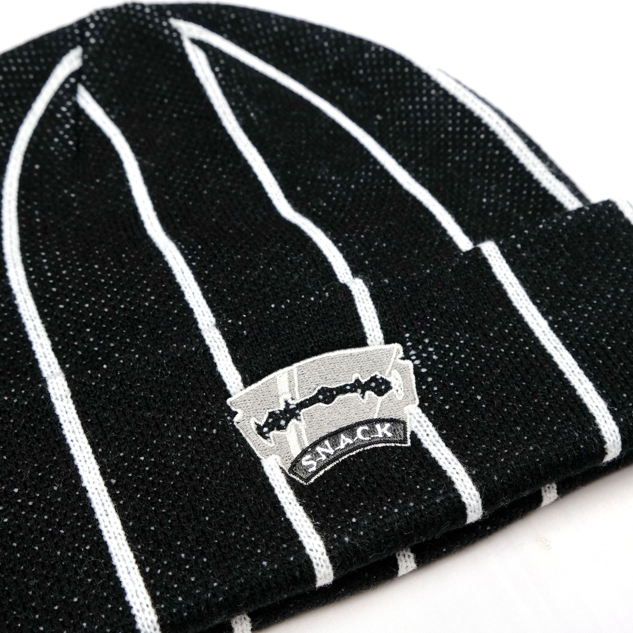 Razor Sharp black/white striped Snack Skateboards beanie close up